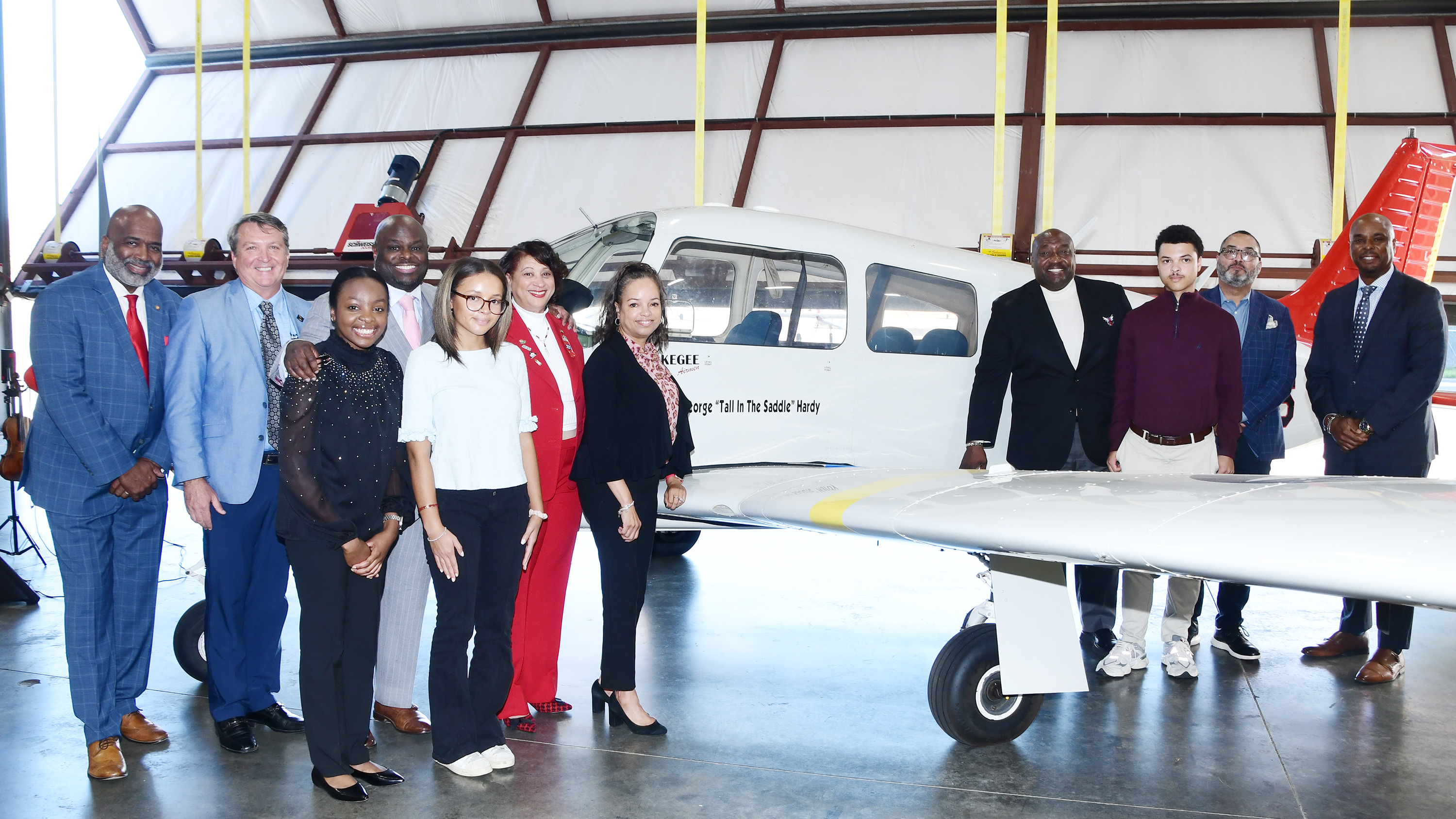 A group of the ceremony attendees pose at the renamed aircraft.