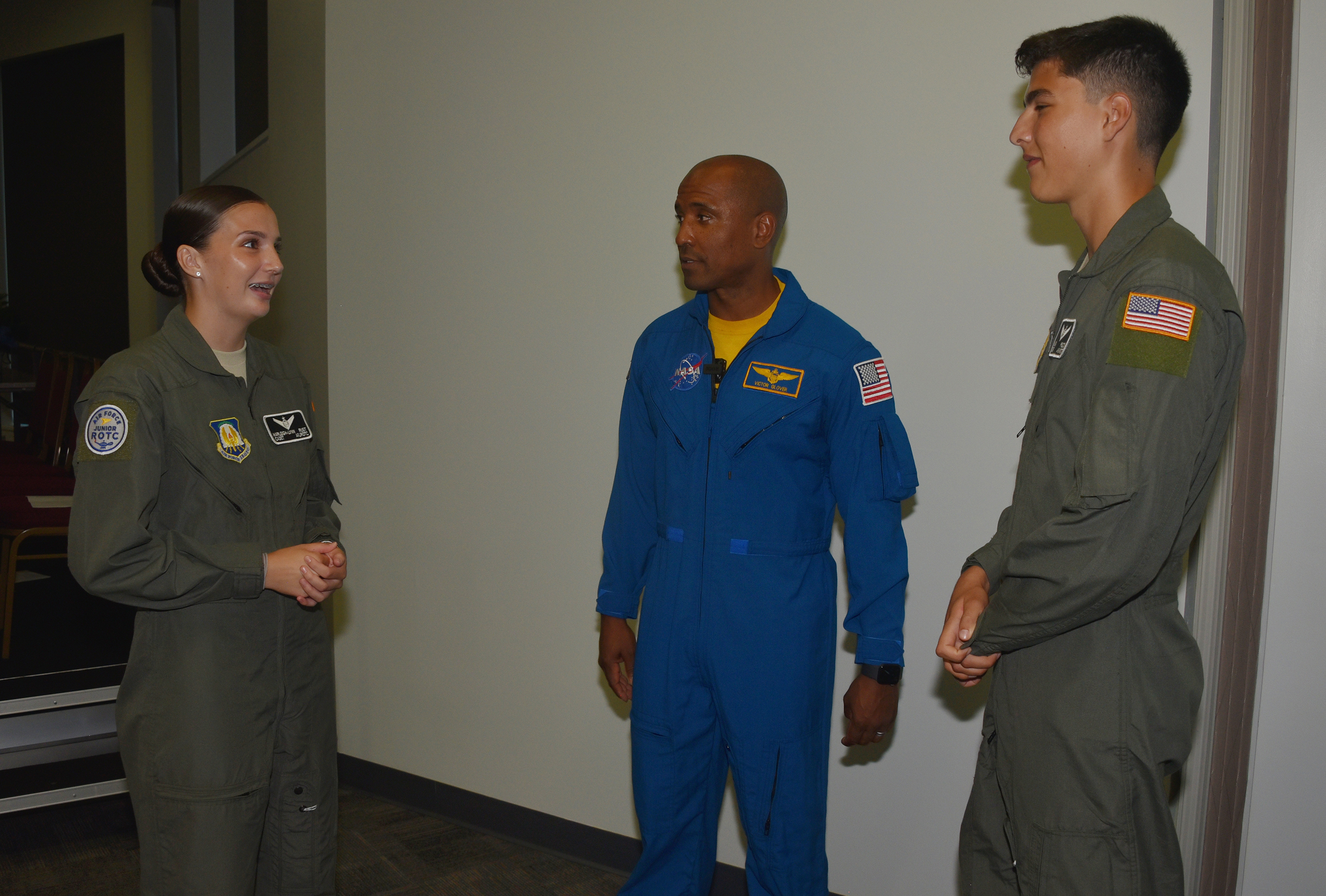 Delaware cadets Harleigh-Lynn Rust (l) and Hayden Pelton chat with Cmdr Victor J. Glover, Jr.