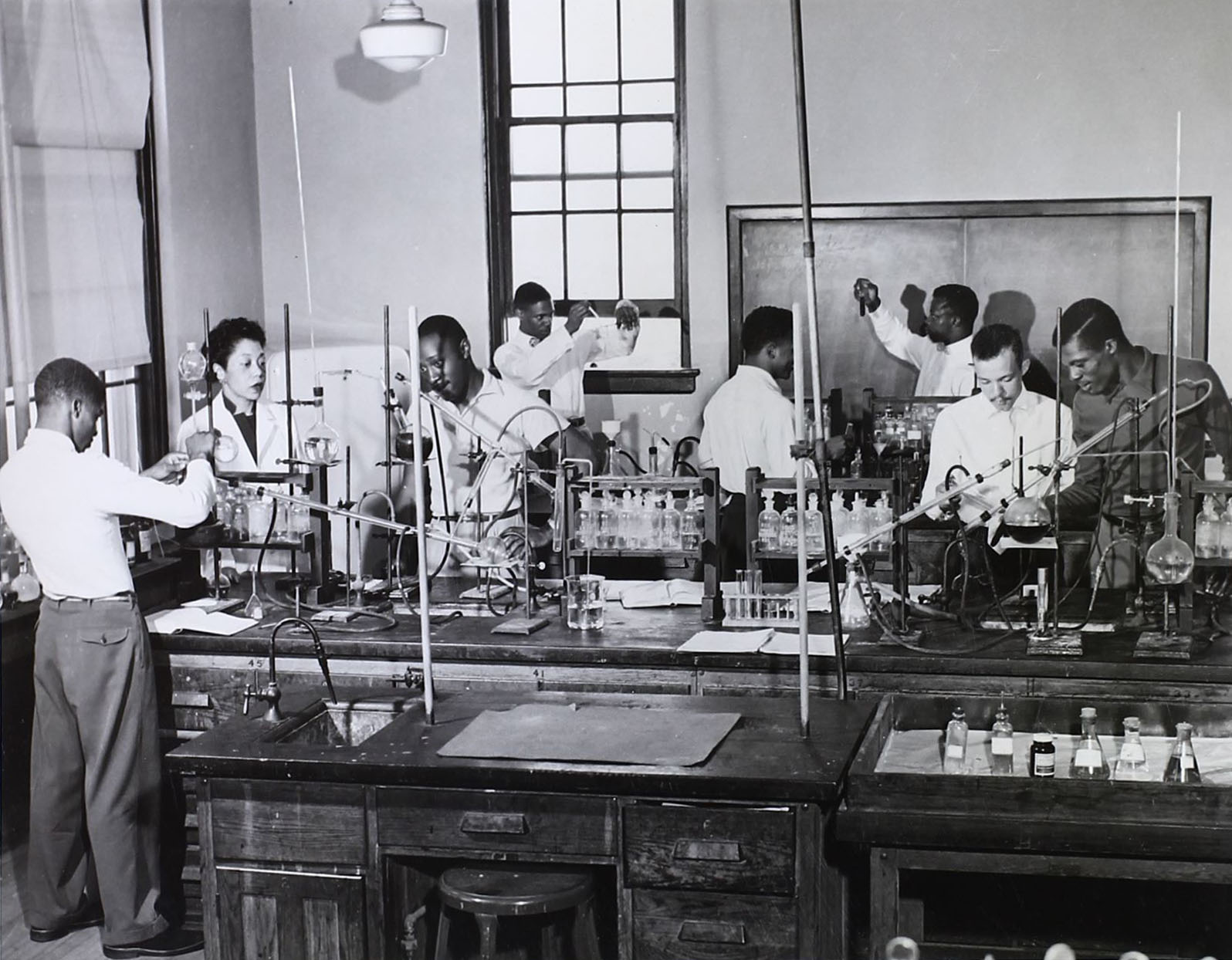 Dr. Harriet Williams (far left) presides over her chemistry lab in the 1940s