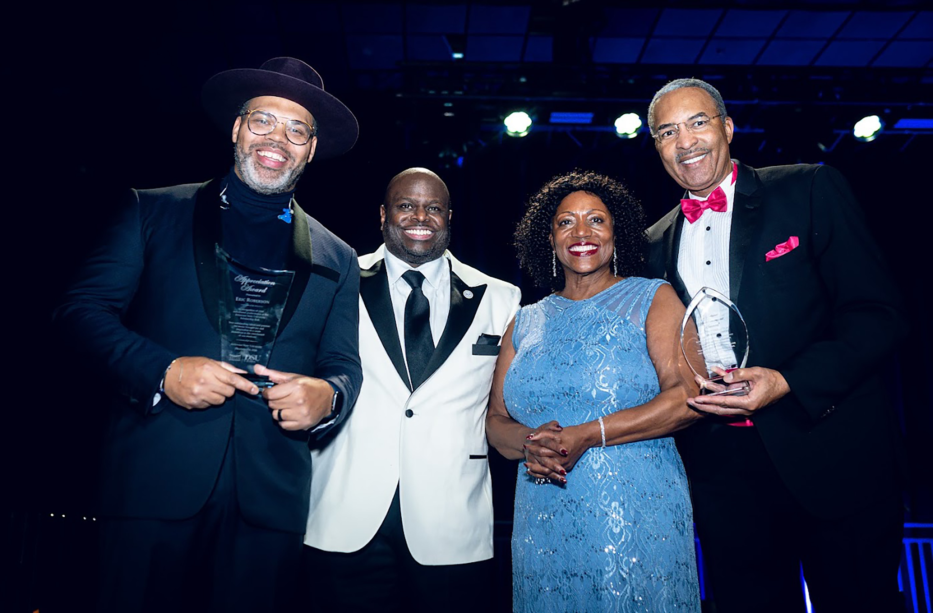 (L-r) Damien Escobar (l) and Ukee Washington (r) receive awards from DSU's Dr. Tony Allen and Dr. Vita Pickrum.