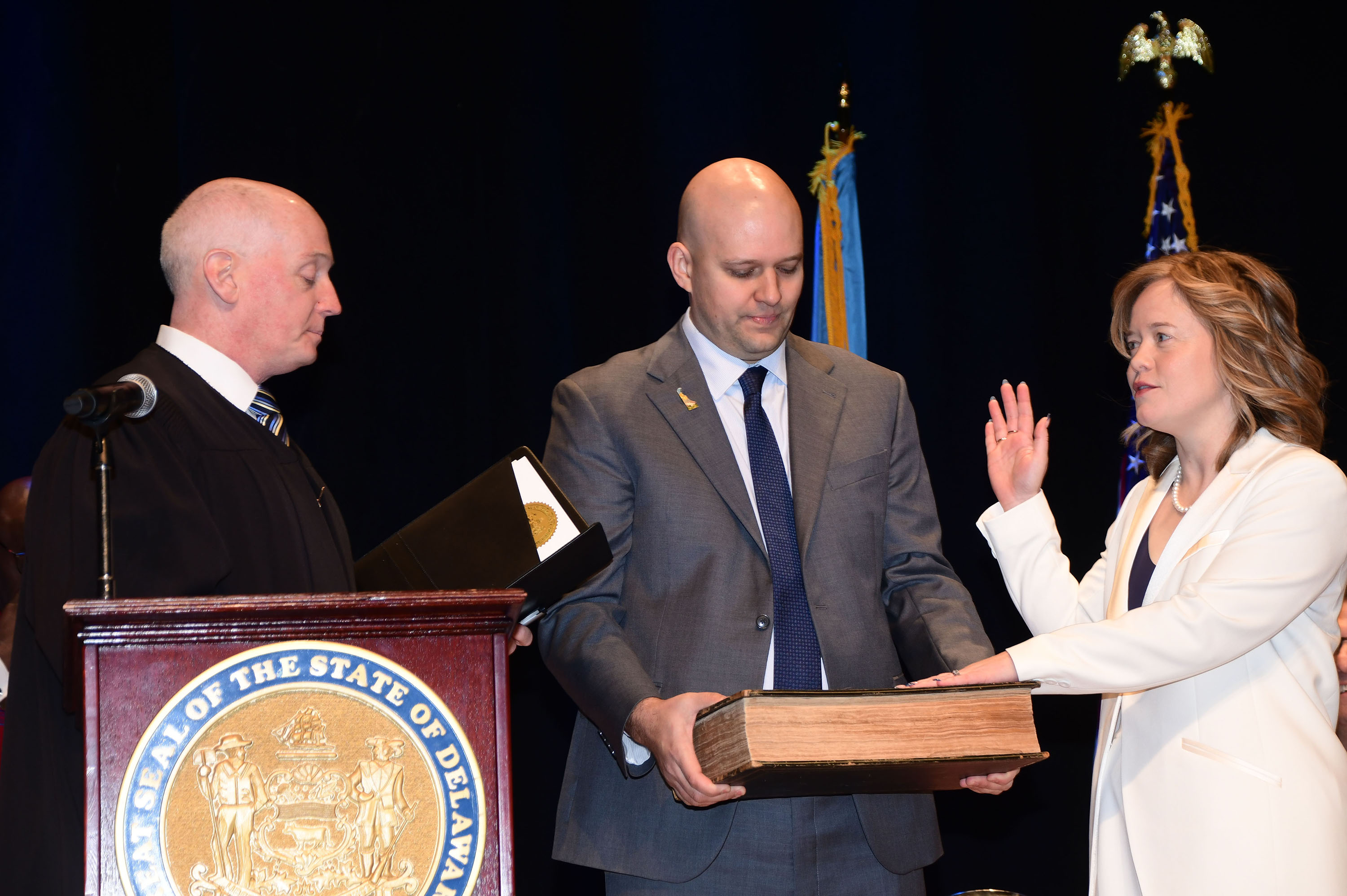 With her husband Olin Gay holding a bible, Lt. Gov. Kyle Evans Gay takes the oath of office.