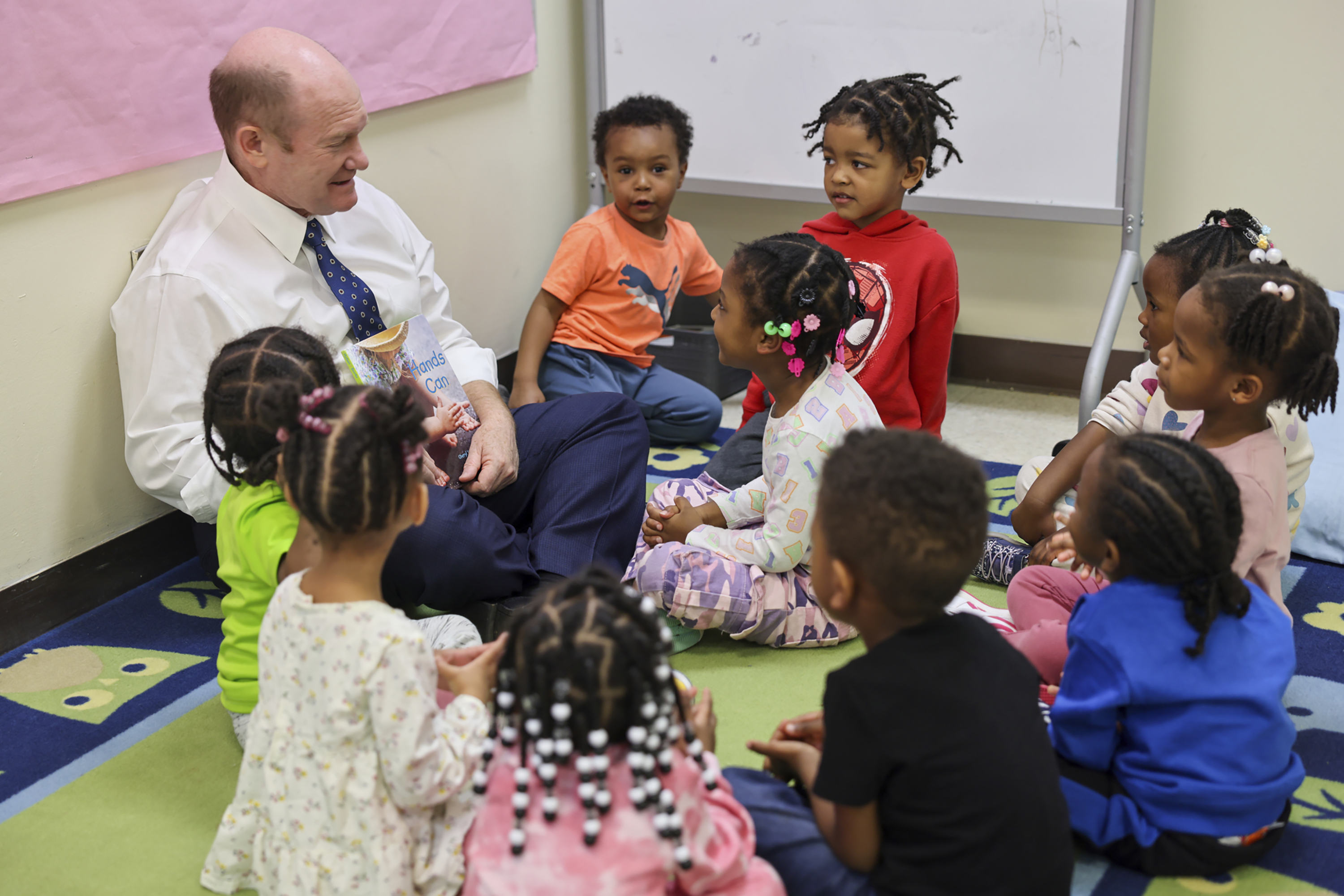 U.S. Sen. Chris Coons takes a break from meeting with faculty and students to spend time with Early Childhood lab children.