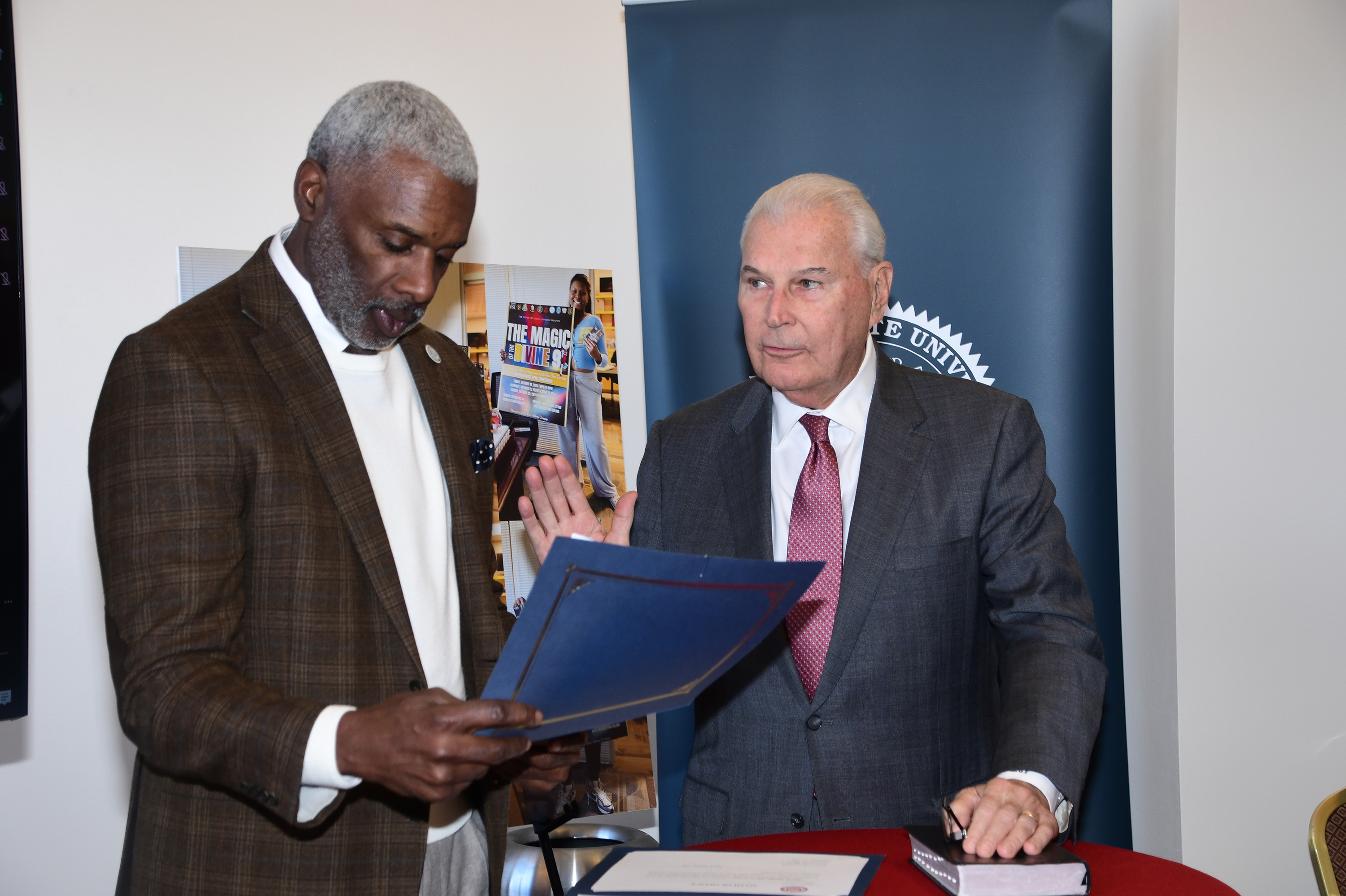 Board Chair Leroy Tice swears in Mayor Michael Purzycki as a new Trustee.