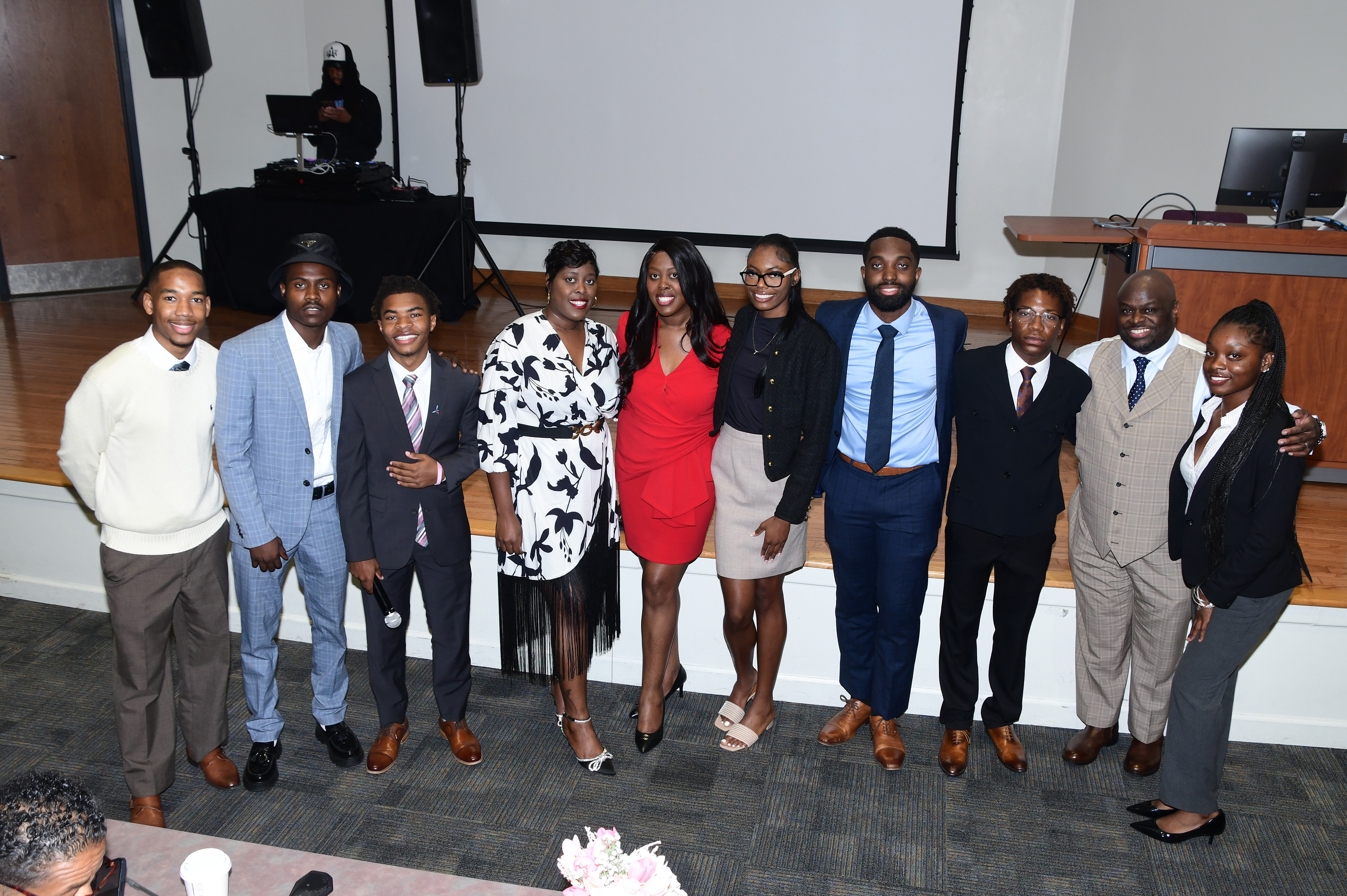 Twin Sisters Dr. Carrie Awadzi and Joann Means are joined in a photo by a team of students and DSU President Tony Allen.