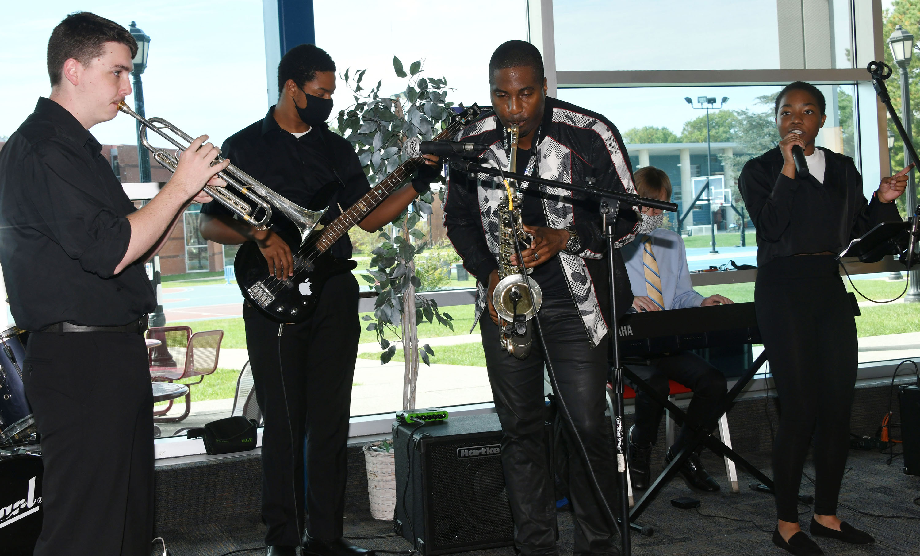 Eric Darius (sax) and other Del State music provide instrumental support as Alyssia Woodard (r) sing "Superstition."