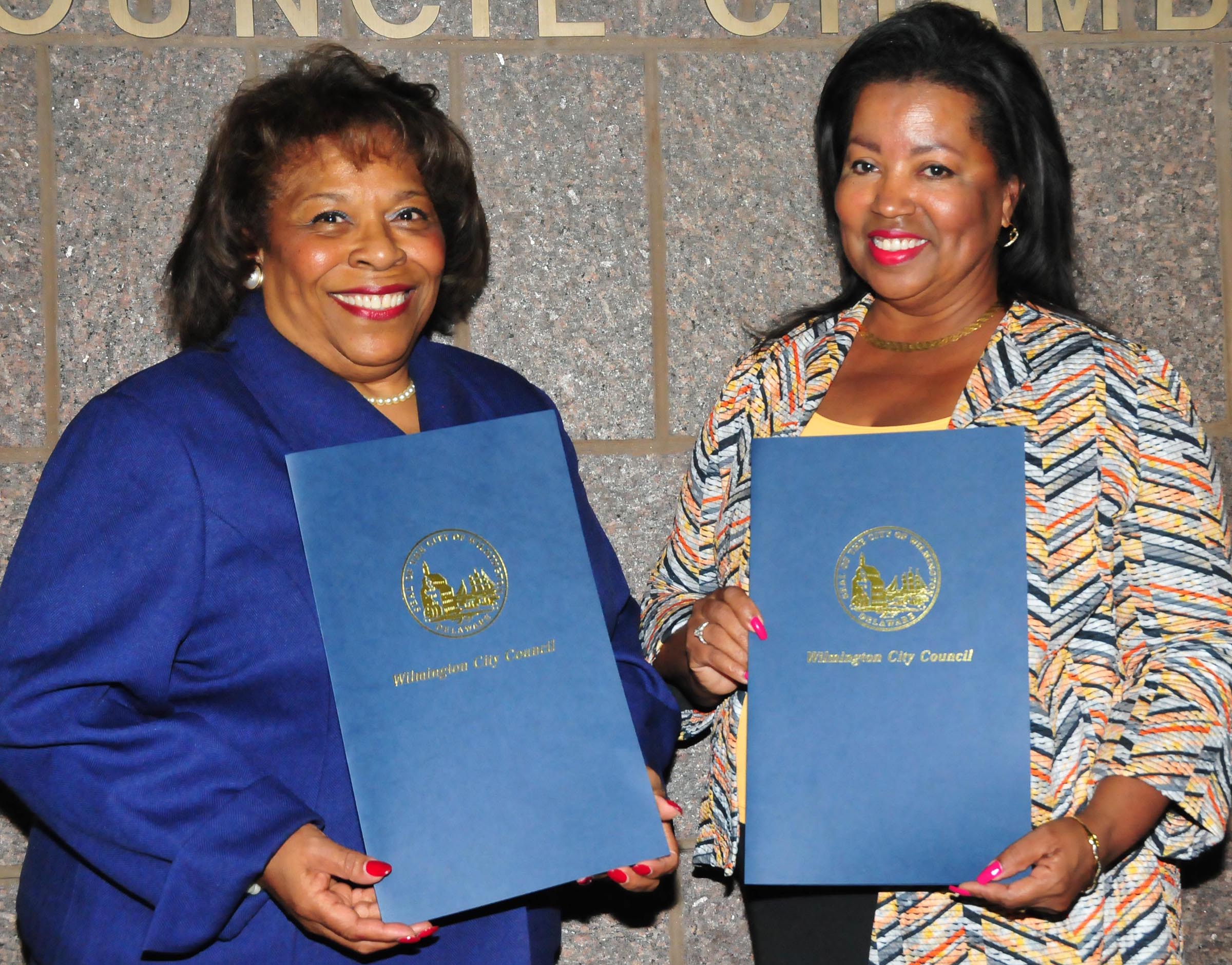 DSU Board Chair Wilma Mishoe and Vice Chair Devona Williams hold resolution presented to them by the Wilmington City Council