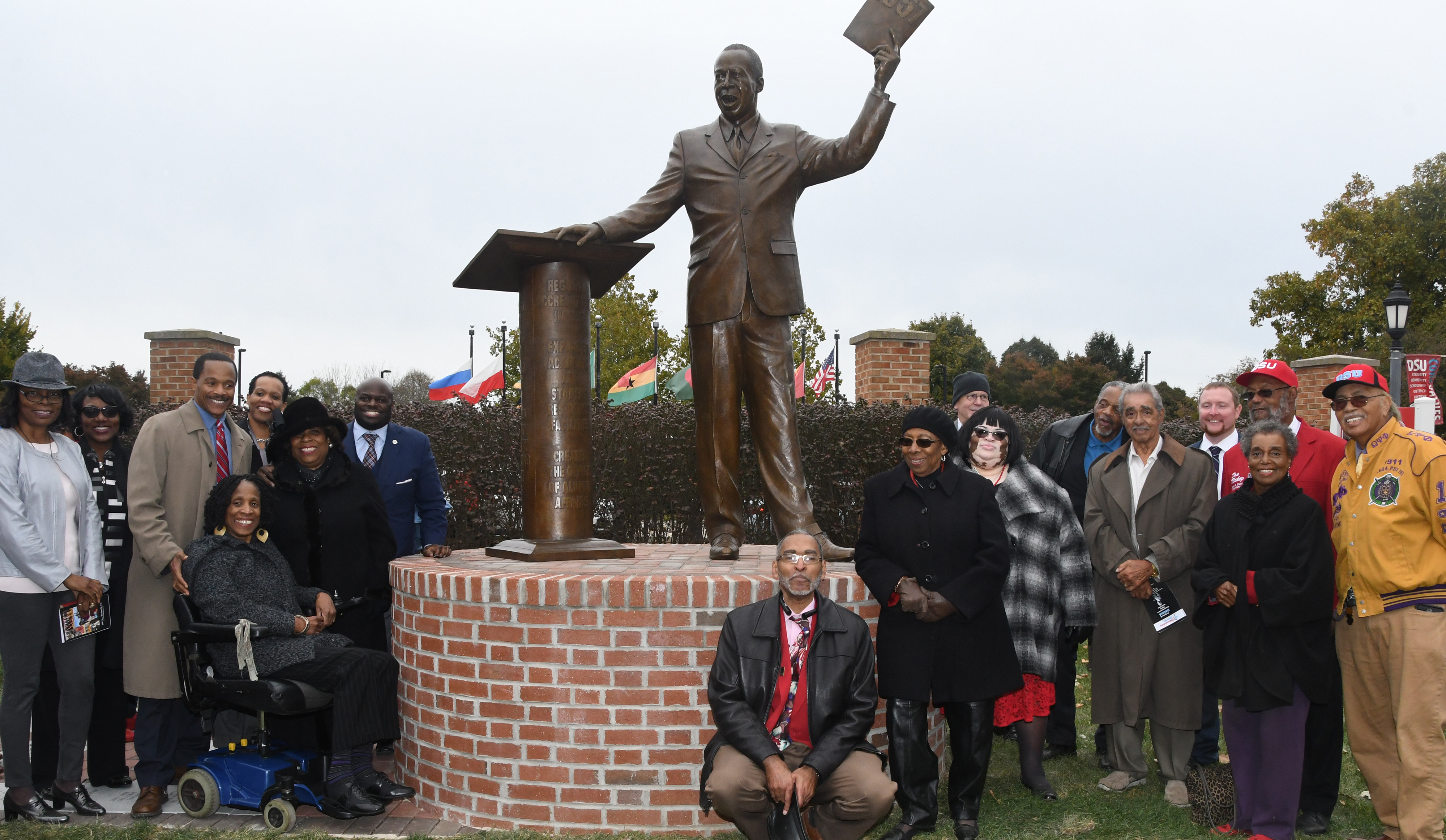 A group which included the Holland children (now adults), University President Wilma Mishoe, Board of Trustees members and the Holland Memorial Statue Committee, posed with the statue of Dr. Jerome H. Holland after the Oct. 26 Dedication Ceremonty