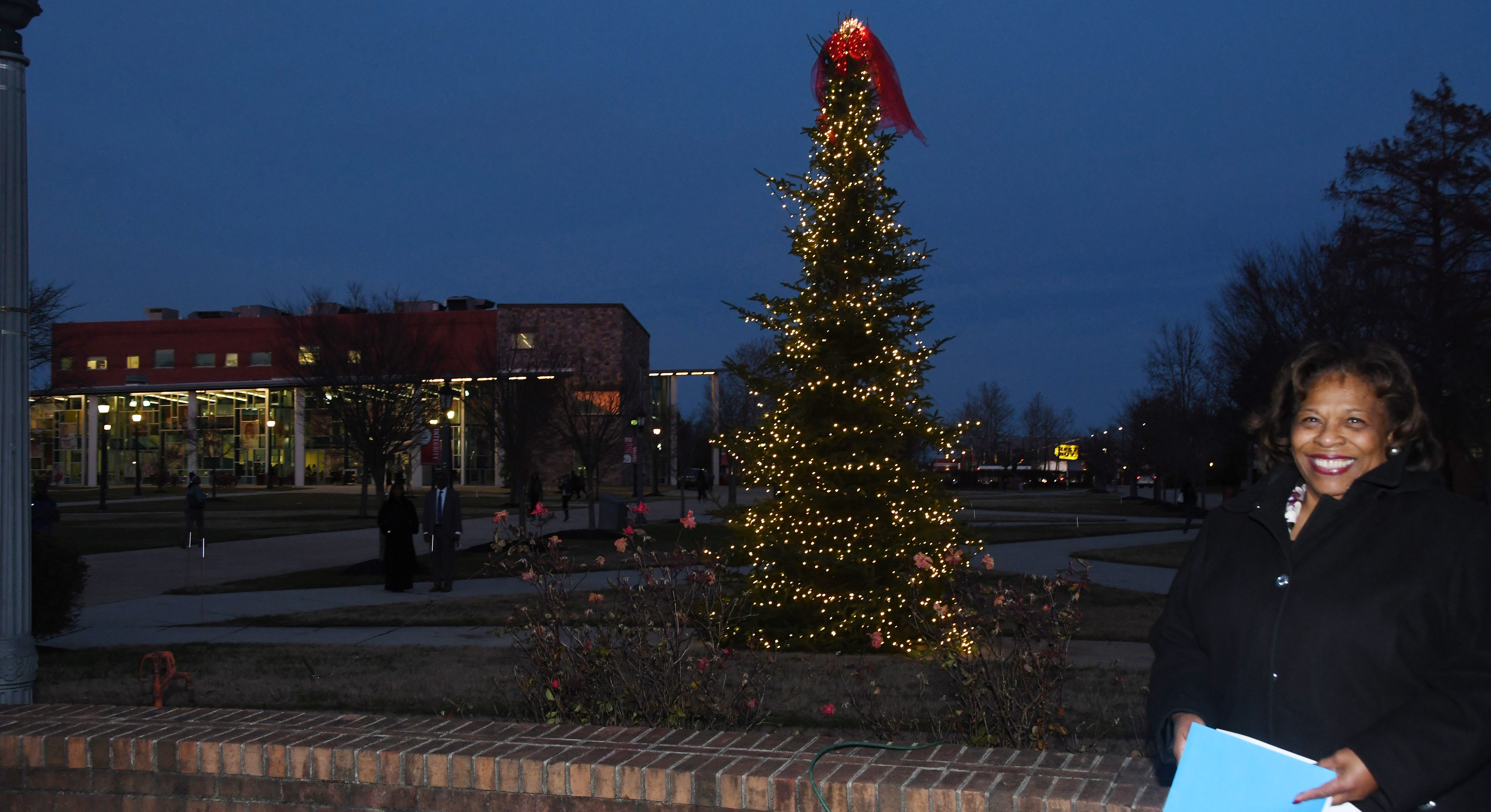 University President Wilma Mishoe stands in from the campus Christmas tree, which she had just lit in a Dec. 3 ceremony outside of the Recreation and Wellness Center.