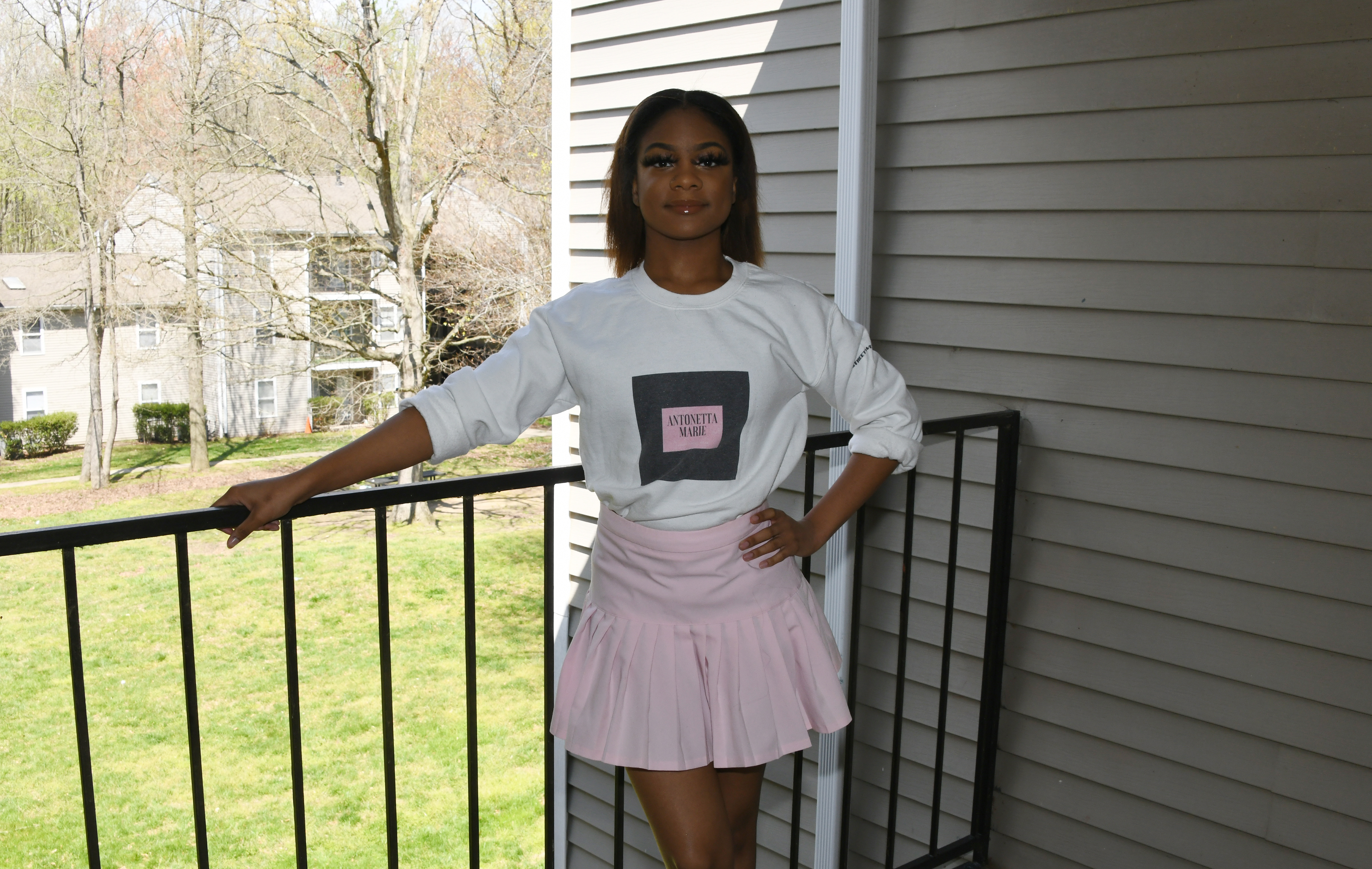 Antonetta M. Savoury, a junior Textiles and Apparel Studies major, models a shirt and skirt outfit that she markets on her Antonetta Marie Luxury Street Wear website business.