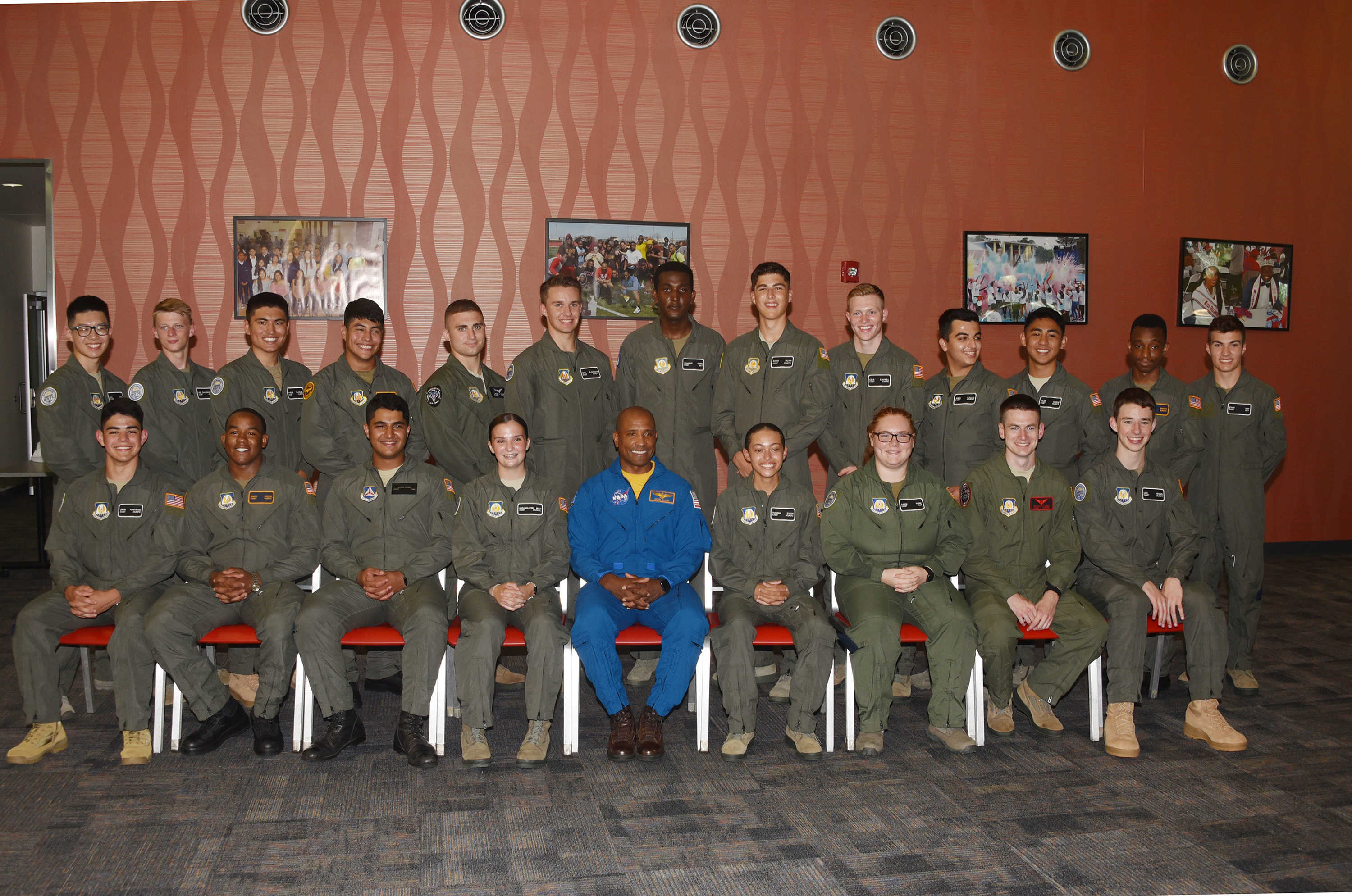 The summer 2021 class of the Cadet Flight Training Program poses with Cmdr. Victor J. Glover Jr. (center in blue), a NASA astronaut who recently returned from a mission on the International Space Station. Cmdr. Glover was the keynote speaker for the program's graduation ceremony.