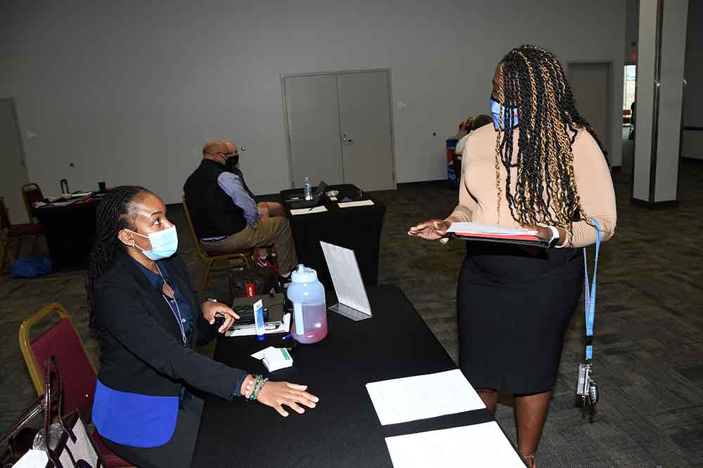 A Delaware State University employee who attended the first-ever Career Opportunity Day event, confers with a department representative. The event gave Del State employees the opportunity to find out about other jobs within the University that might be a good fit for their talents and skills.