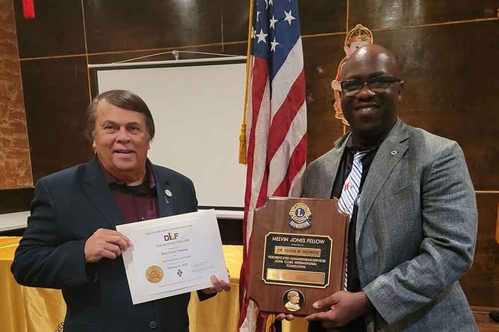 Dover Mayor Robin R. Christiansen poses with Dr. Esosa Irriowen after presenting him with the Melvin Jones Fellow Award and the Ted Reiver Fellow Award during a Dover Lions Club dinner event.