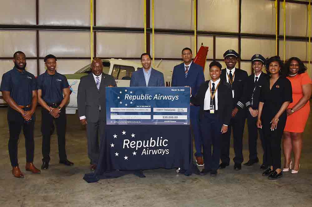 Republic Airlines and Delaware State University representatives pose with a display check symbolizing a $30,000 recently donated by the airline provider to the University's Aviation Program..