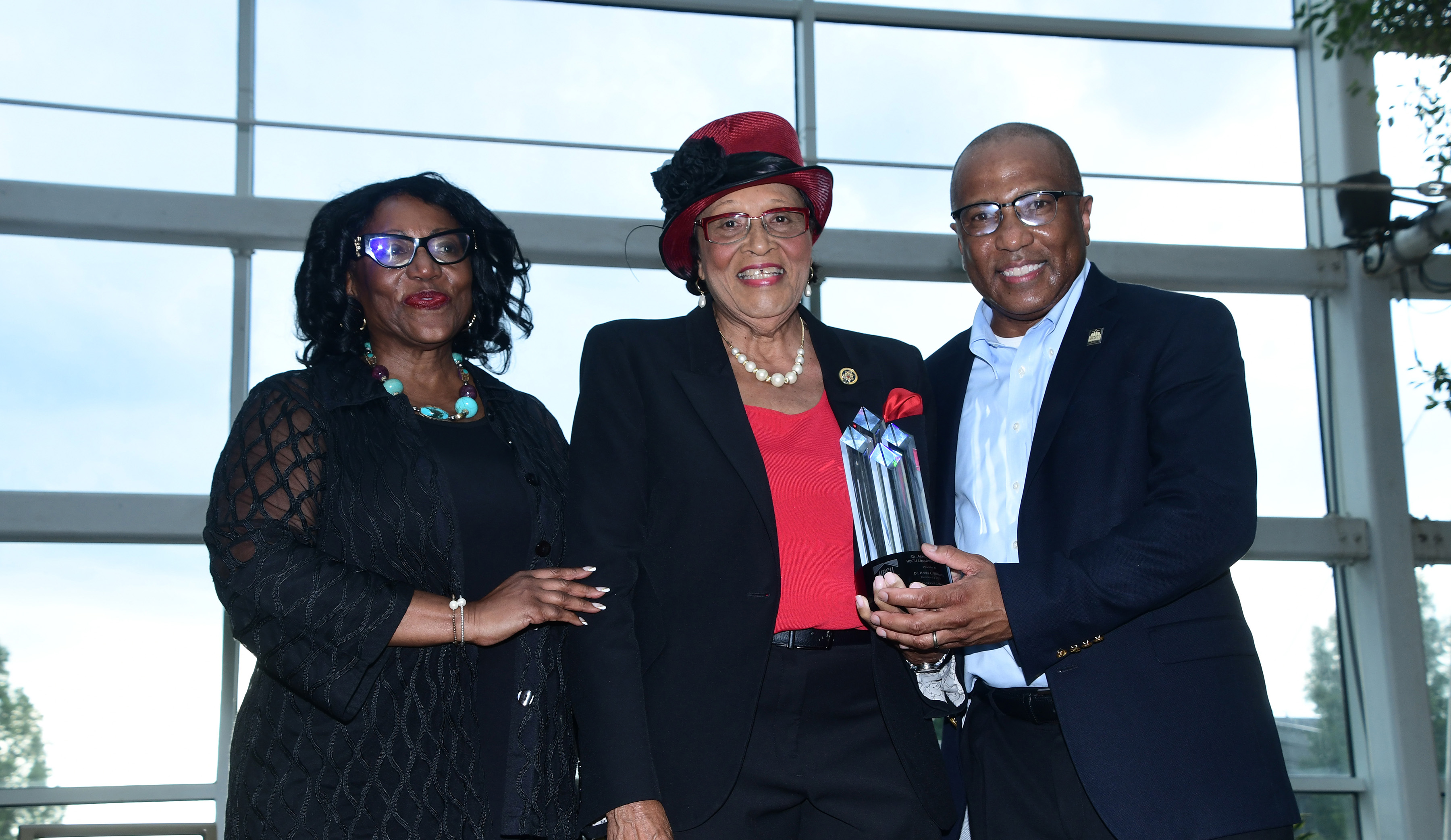 Dr. Harry L. Williams (r), CEO and President of the Thurgood Marshall College Fund, receives the inaugural Dr. Alma Adams Leadership Award from Dr. Vita Pickrum (l) and Congresswoman Alma S. Adams during the first day of the HBCU Philanthropy Symposium in National Harbor, Md. 