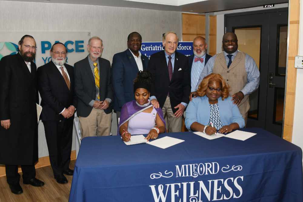 (Seated l-r) Dr. Kemi Ogunwusi of the Milford Wellness Village; and DSU's Dr. Gwen Scott-Jones, Dean of the College of Health and Behavioral Sciences, sign the partnership agreement between Delaware State University and Education, Health and Research International, Inc. (EHRI) Standing (l-r) Rabbi Y. Halberstam, EHRI Director of Public Affairs; Meir Gelley, President of Nationwide Healthcare Services; State Sen. Harris McDowell; Milford Vice Mayor Jason L. James; U.S. Tom Carper; Milford Mayor F. Todd Culotta; and DSU President Tony Allen.