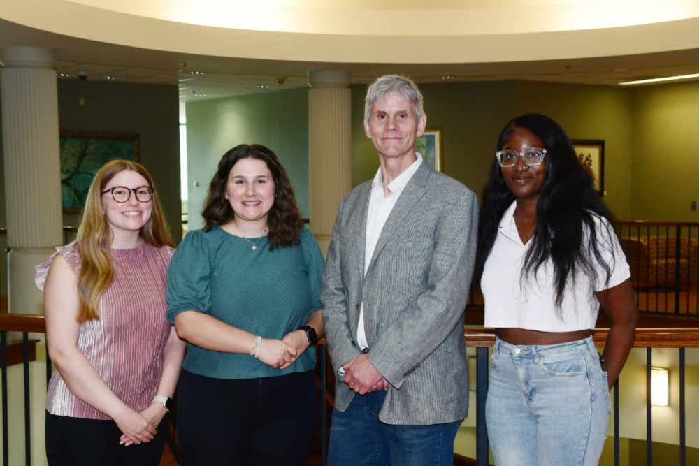 (L-r) Skylar Tenan, Emily Breidegam, Dr. Scott Zoldi, FICO's Chief Analytics Officer, and Emanuela Halm. All three students are senior Business Analytics majors and are participating in FICO's Analytics Challenge.  