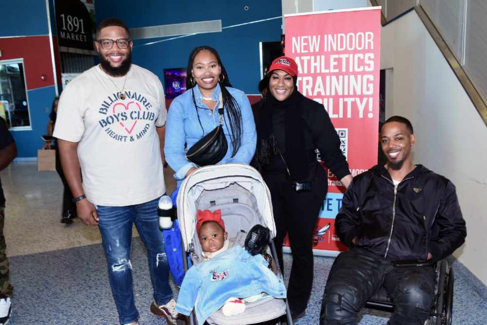 Some Delaware State University alumni (and a future Hornet) pose for a Kodak moment in the Martin Luther King Jr. Student Center during Homecoming on Saturday.