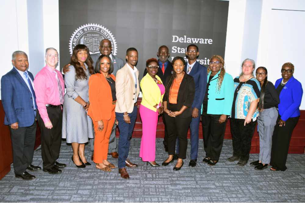 DSU officials pose with their partners from Barbados Community College. The BCC officials include (beginning with the gentleman near the center in the beige suit jacket, l-r) Hakeem Greenidge, Dr. Caroline Woodroffe-Holder, Dr. Raquel Collymore, and Samuel Bowen.