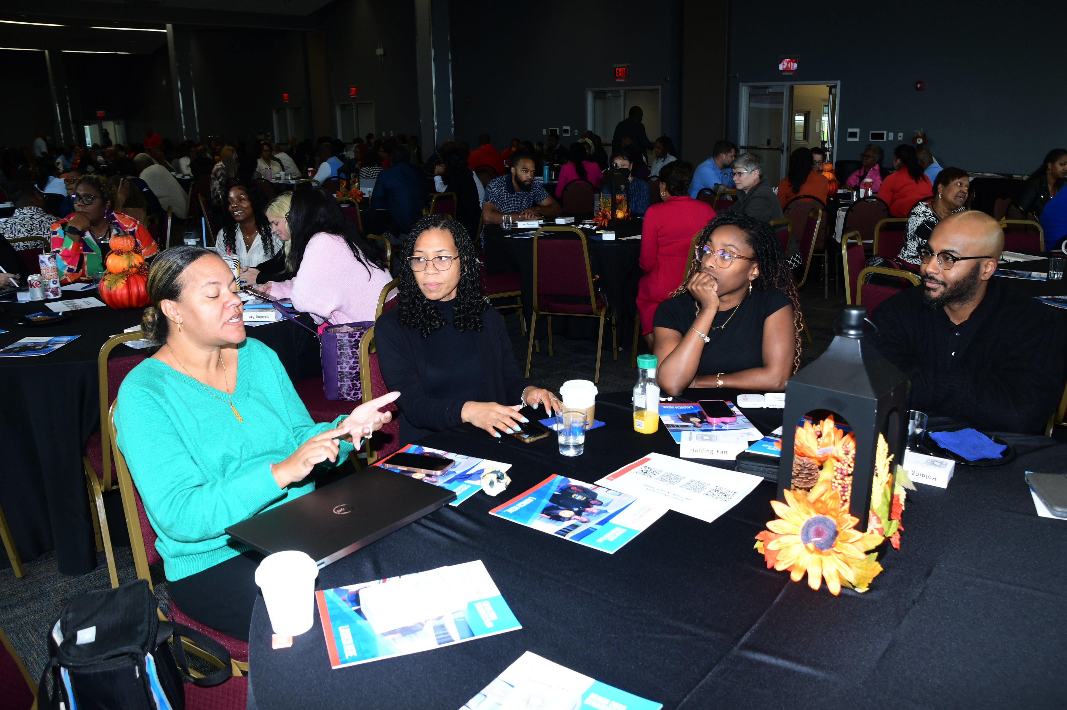 Stacey Wilkerson (far left), Administrative Secretary for the School of Graduate, Adult and Extended Studies, makes a point during a group discussion portion of the Staff Institution.