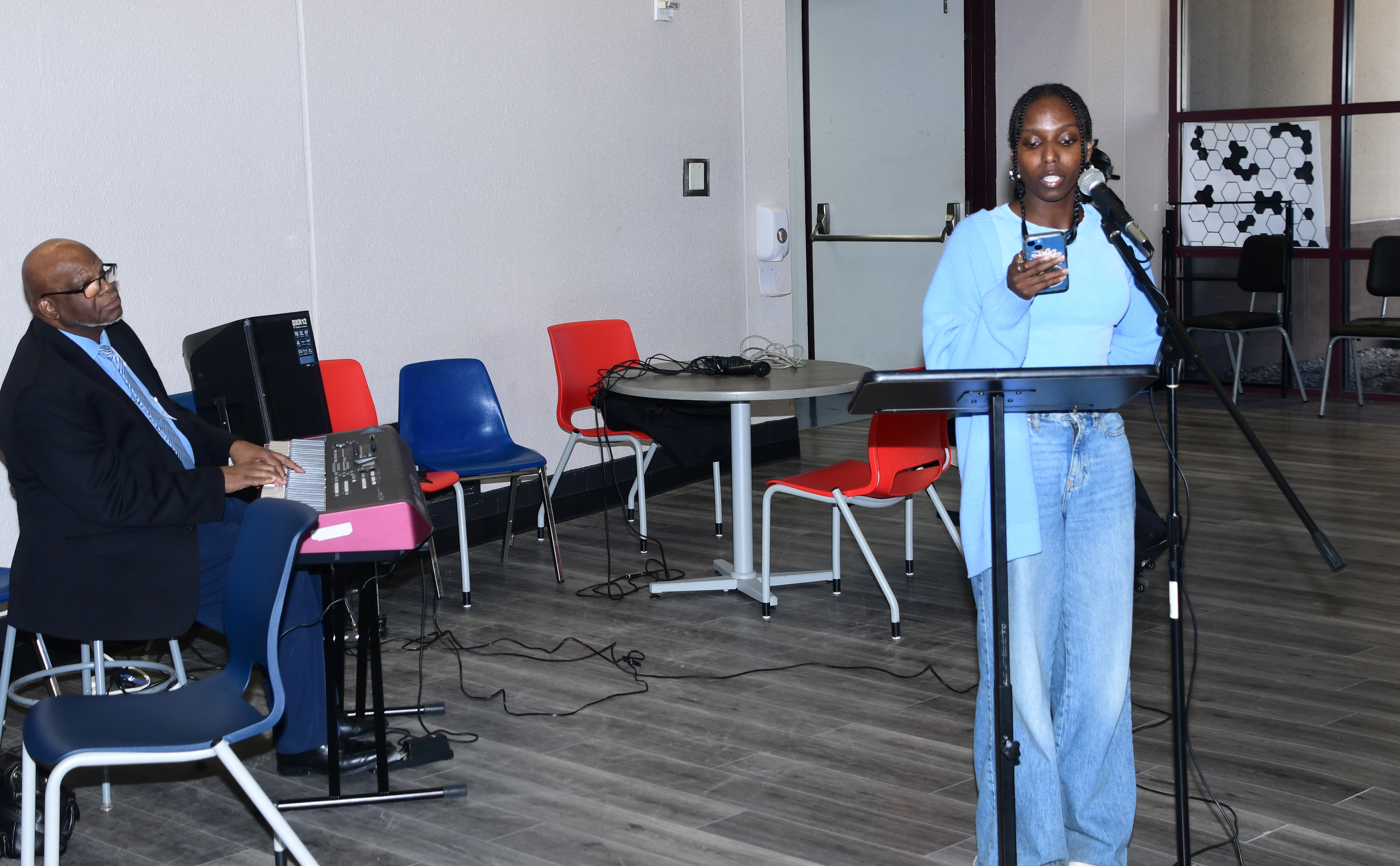 DSU student Tianna Muiruri reads her original poem "Tears" at the Oct. 17 Poetry Slam in the atrium lobby of the Education and Health Building.