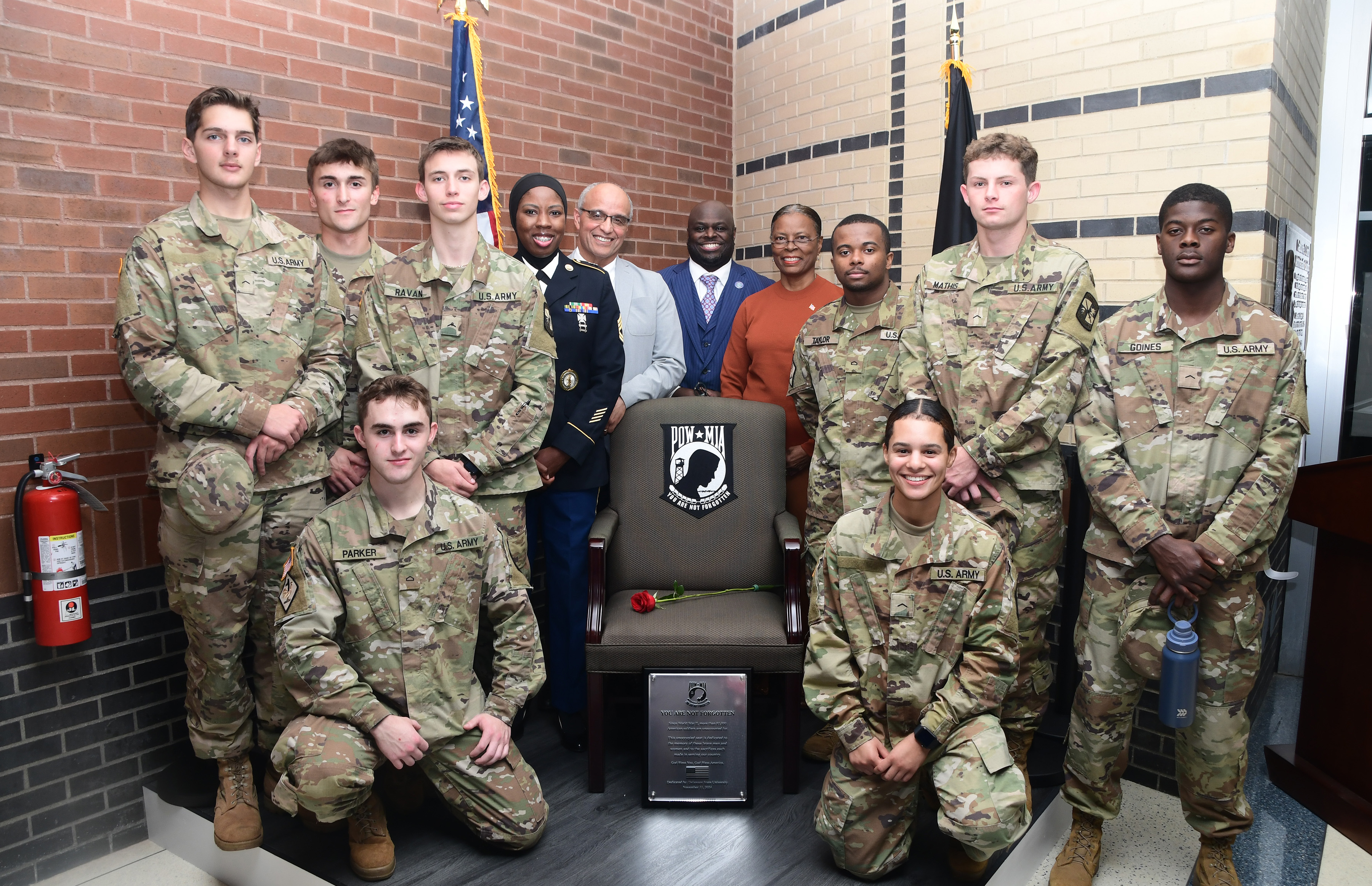 Members of the DSU U.S. Army ROTC pose at the POW-MIA "Chair of Honor"  along with SFC Chareedra Othman, Andre Swegert, DSU President Tony Allen, and Col. (ret.) Debbie Harrington. The Chair of Honor has been permanently installed in the northwest corner on the first floor of the Claibourne D. Smith Administration Building.