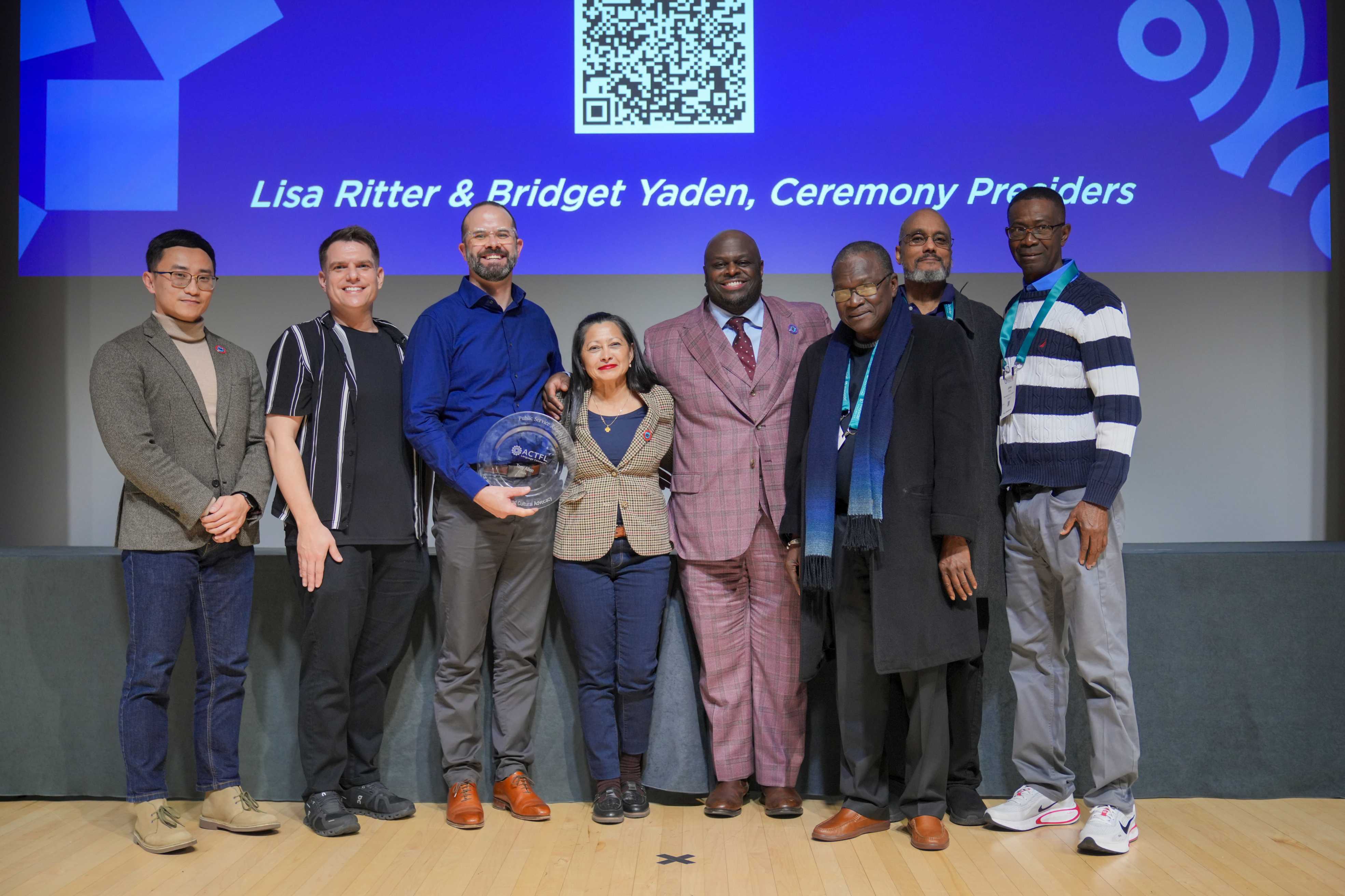 DSU Languages and Literature faculty: (l-r) Dr. Yi Zhang, Dr. Joseph Fees, Dept. Chair Dr. Brody Bluemel, Vilma Lazo-Butera, DSU President Tony Allen, Dr. Ladji Sacko, Dr. Edward Dawley, and Dr. John Teye. The group poses for a picture to celebrate receiving the ACTFL's Public Service Award for World Language and Cultural Advocacy.