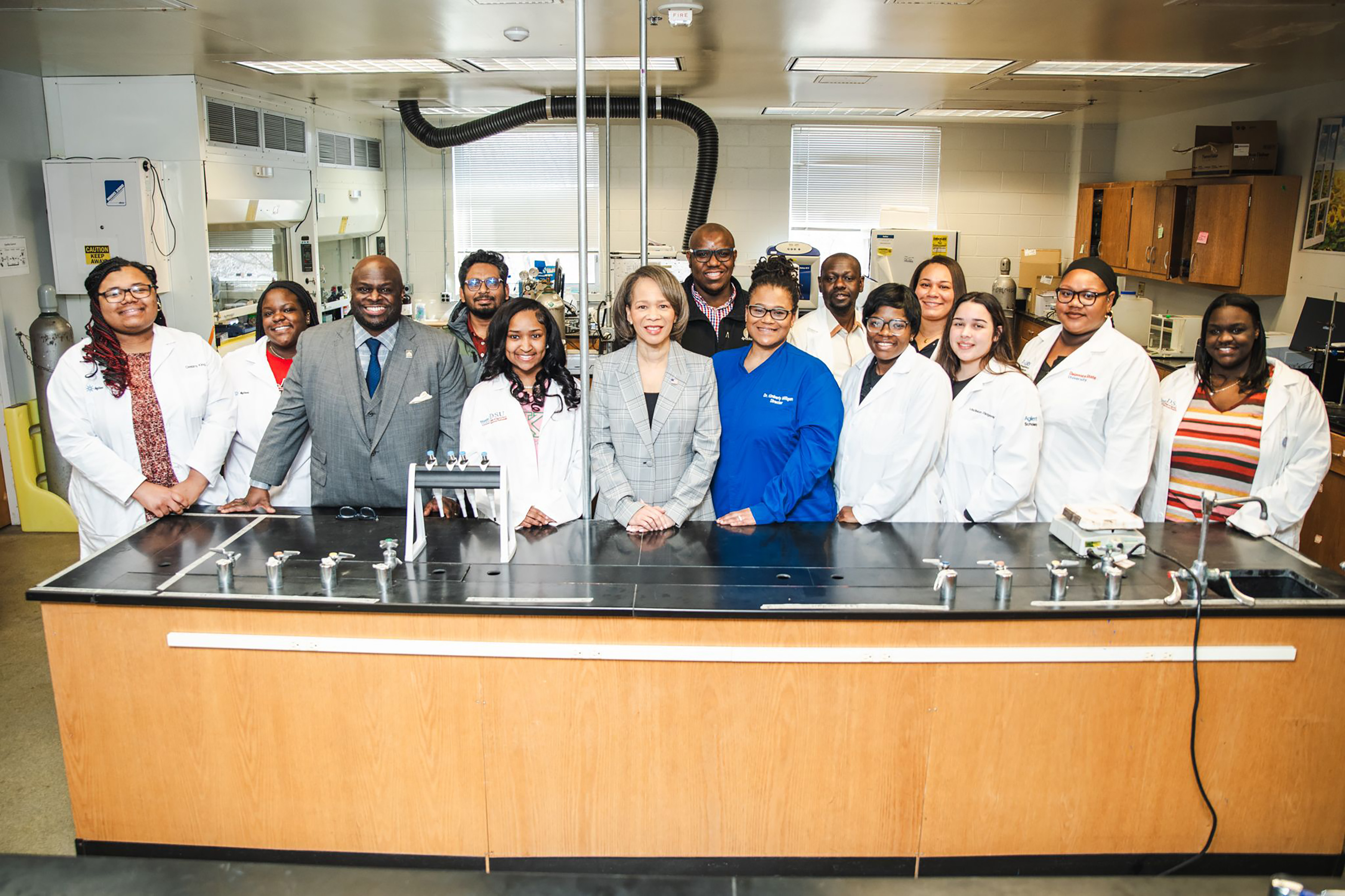 Delaware U.S. Sen. Lisa Blunt Rochester (center) joins DSU President Tony Allen (3rd from left), faculty and staff for a photo moment in one of the labs of the Mishoe Science Center..