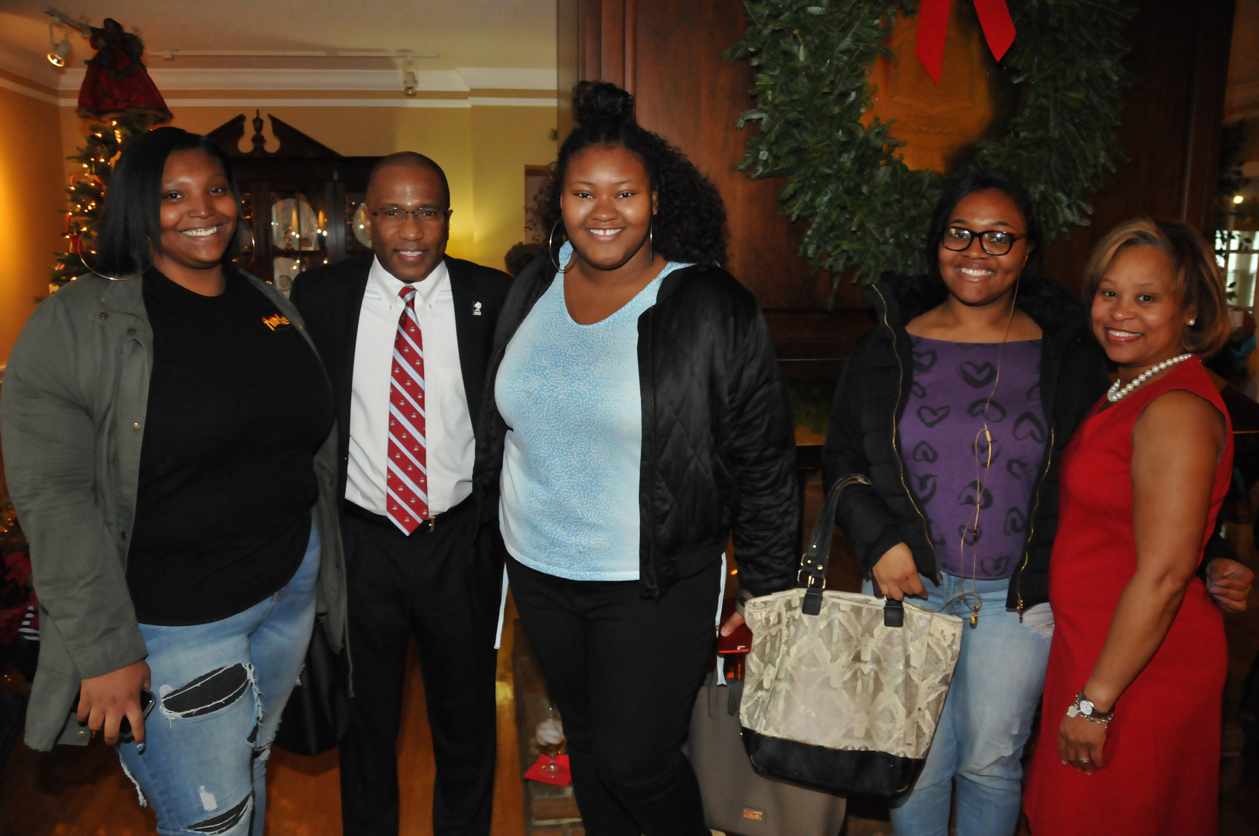 DSU President Harry L. Williams and First Lady Dr. Robin Williams pose with a group DSU students during their Christmas celebration at their residence.